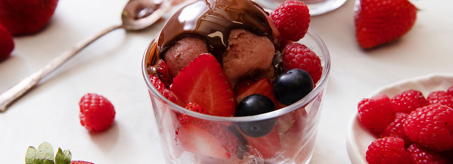 strawberry ice cream sundae with chocolate sauce on top
